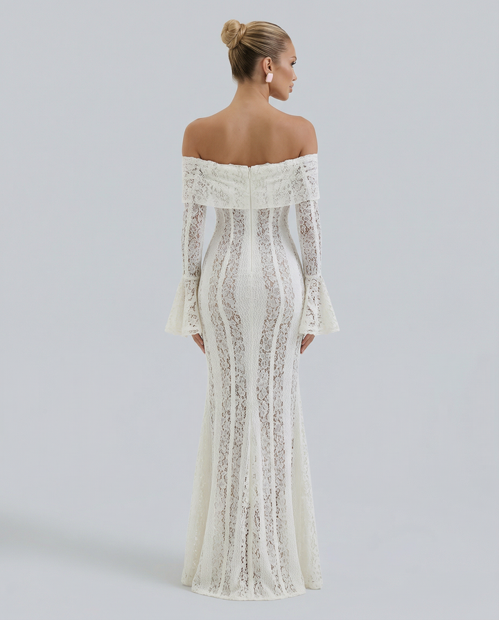 Model wearing a white floral lace maxi dress with a fitted bodice against a plain background.