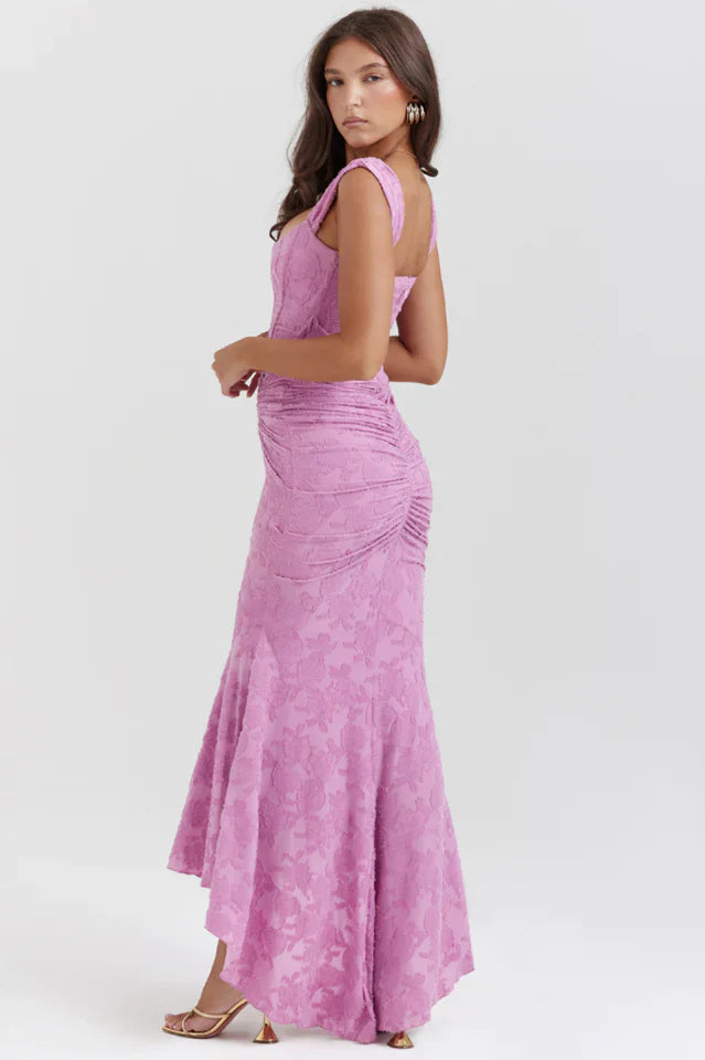 Female model in a formal maxi dress with ruched waist detail.