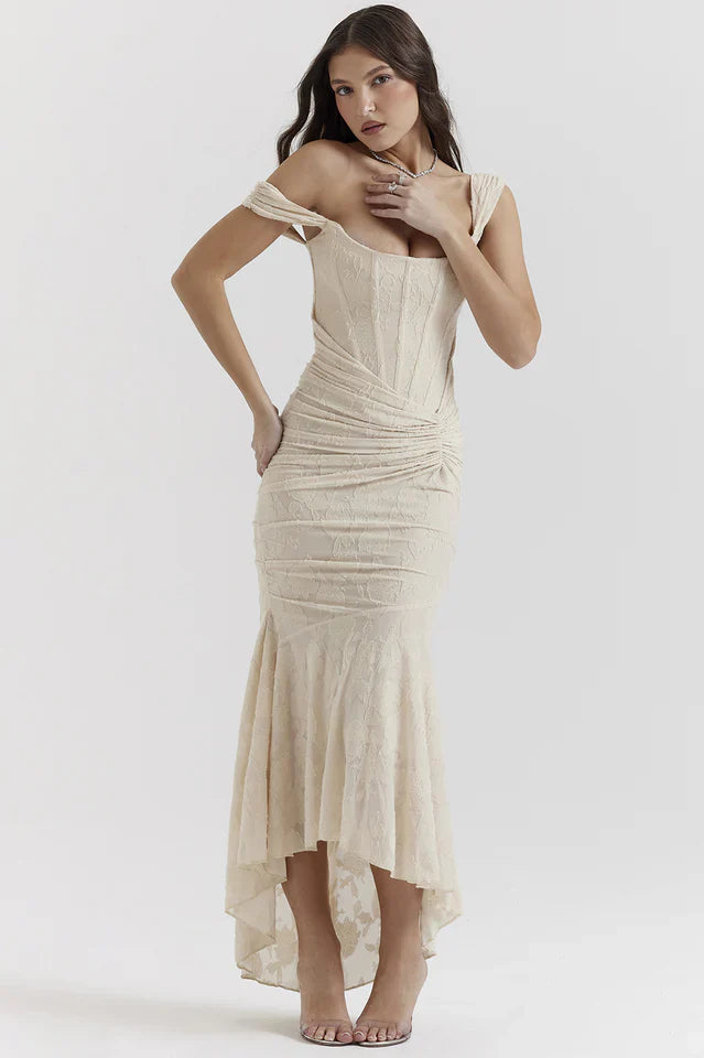 Female model wearing a sleeveless  maxi dress with subtle floral texture.