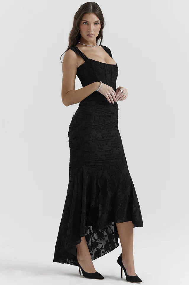 Model wearing a sleeveless maxi dress with ruched waist on a plain background.