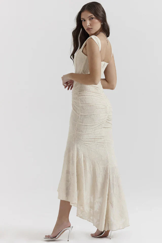 Model in a rose formal dress with structured bodice against a plain background.