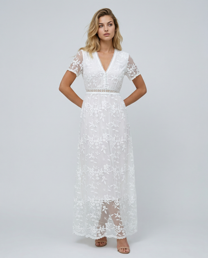 Female model wearing a floral tiered maxi dress against a plain background.