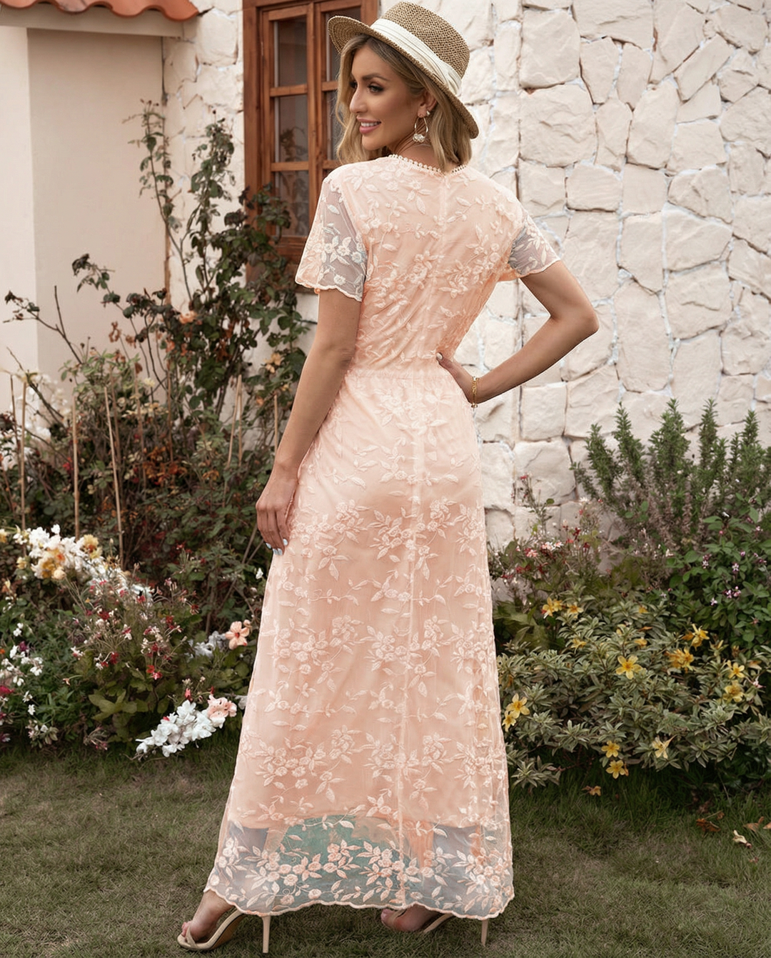Female model wearing a high neck floral maxi dress with ruffle accents on a plain background.