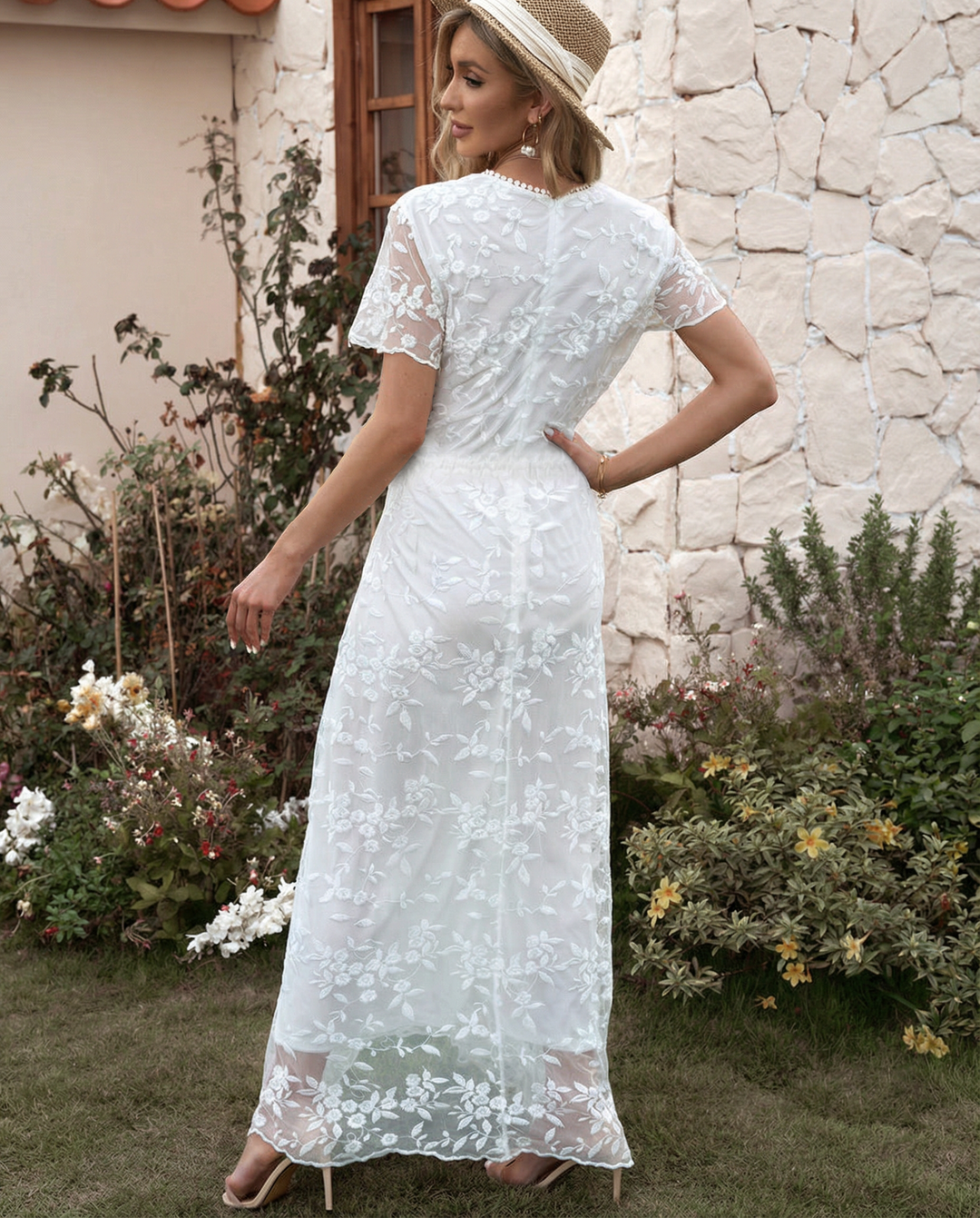 Woman wearing a high neckline floral dress with tiered layers against a plain background.