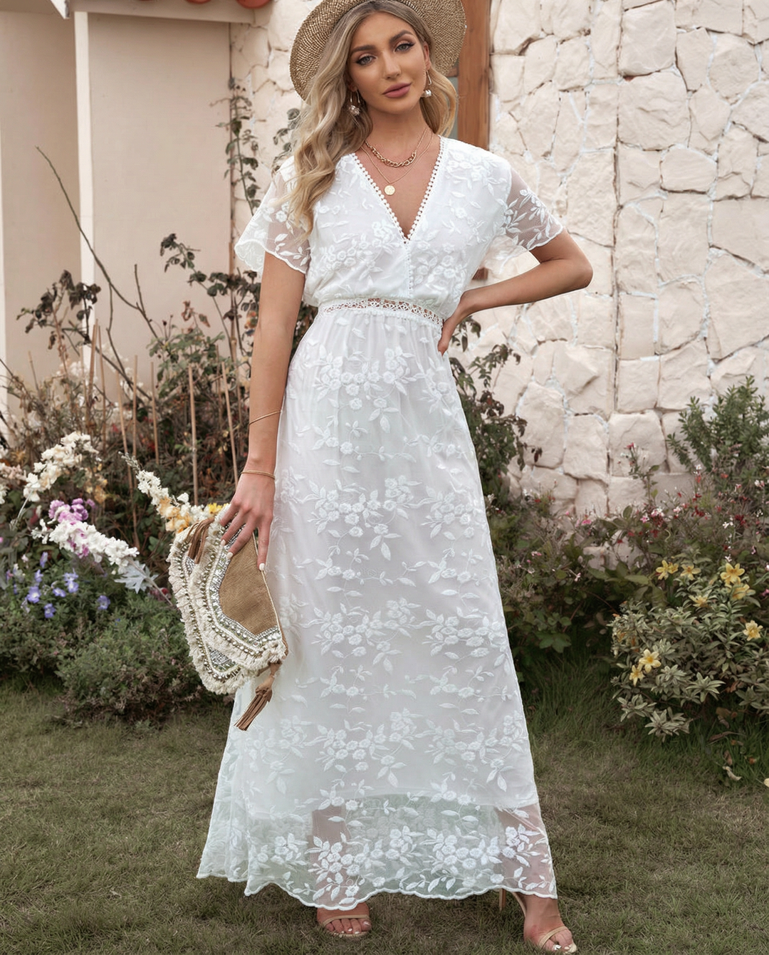 Female model styled in a long sleeve floral maxi dress on a plain background.
