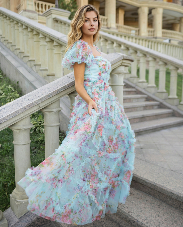 Model wearing a purple floral maxi dress with tiered skirt and puff sleeves.