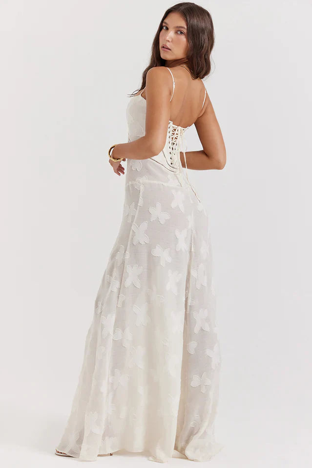 Model wearing a black floral maxi dress with a sweetheart neckline on a plain background.