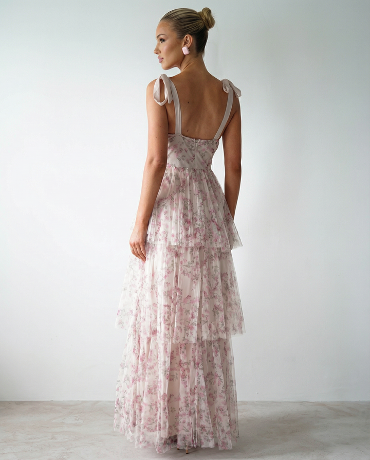Model wearing a sleeveless white maxi dress with a sweetheart neckline on a plain background.
