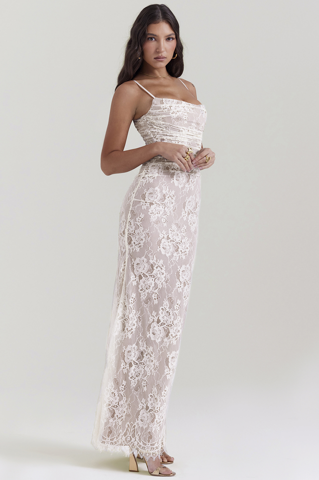 Female model wearing a black fitted lace dress with flowing maxi length.