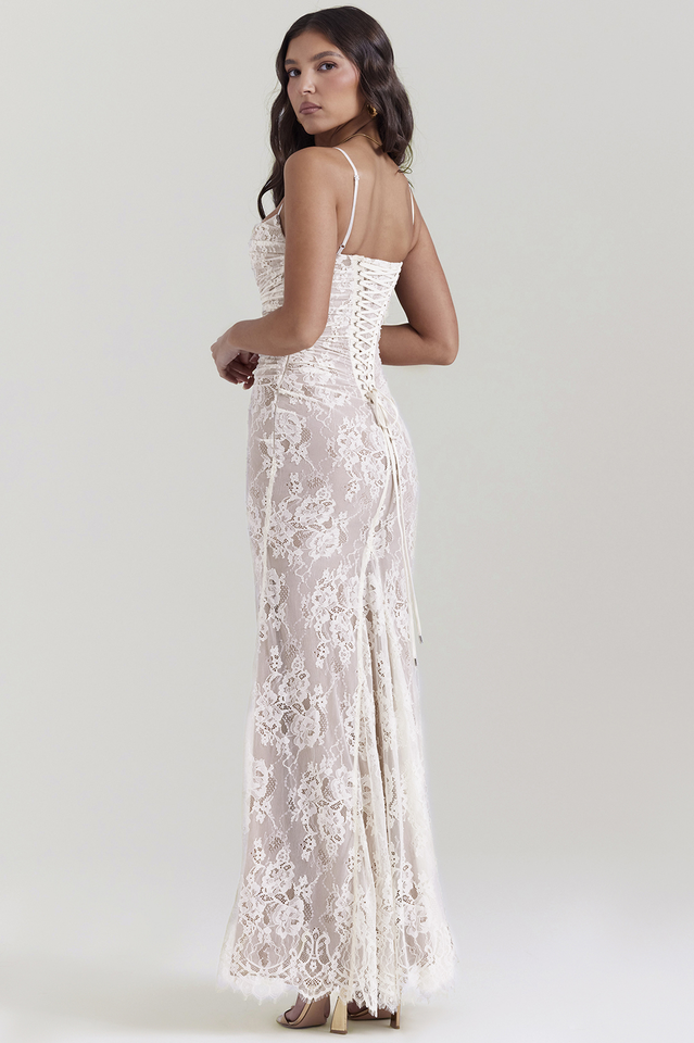 Woman posing in a lace maxi dress with thin straps and sheer sleeve detail