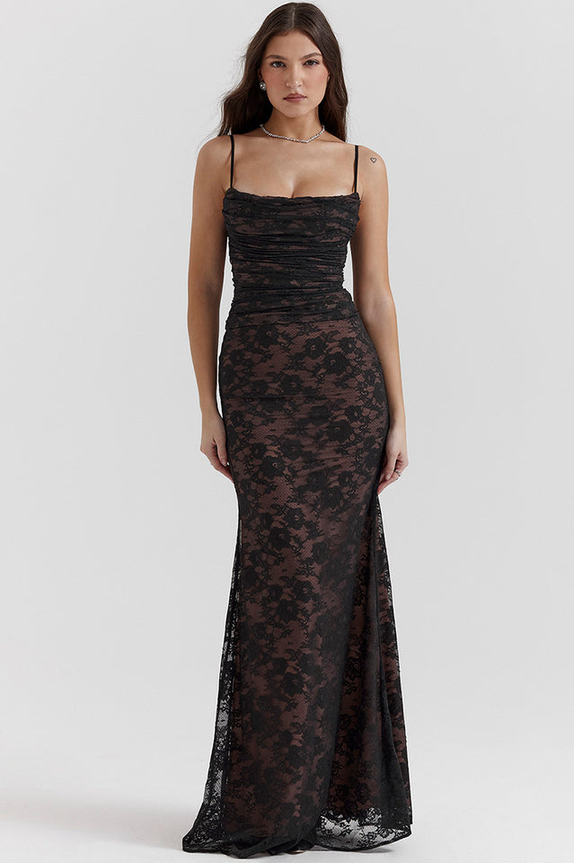 Woman wearing a fitted black lace maxi dress with long sleeves against a plain background.