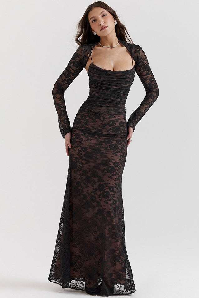 Female model showcasing a lace maxi dress with corset-style back and sheer sleeves.