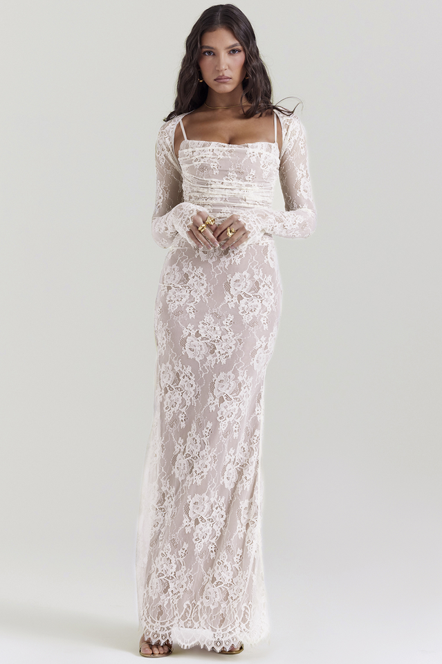 Female model in a white lace long sleeve maxi dress with straight neckline.