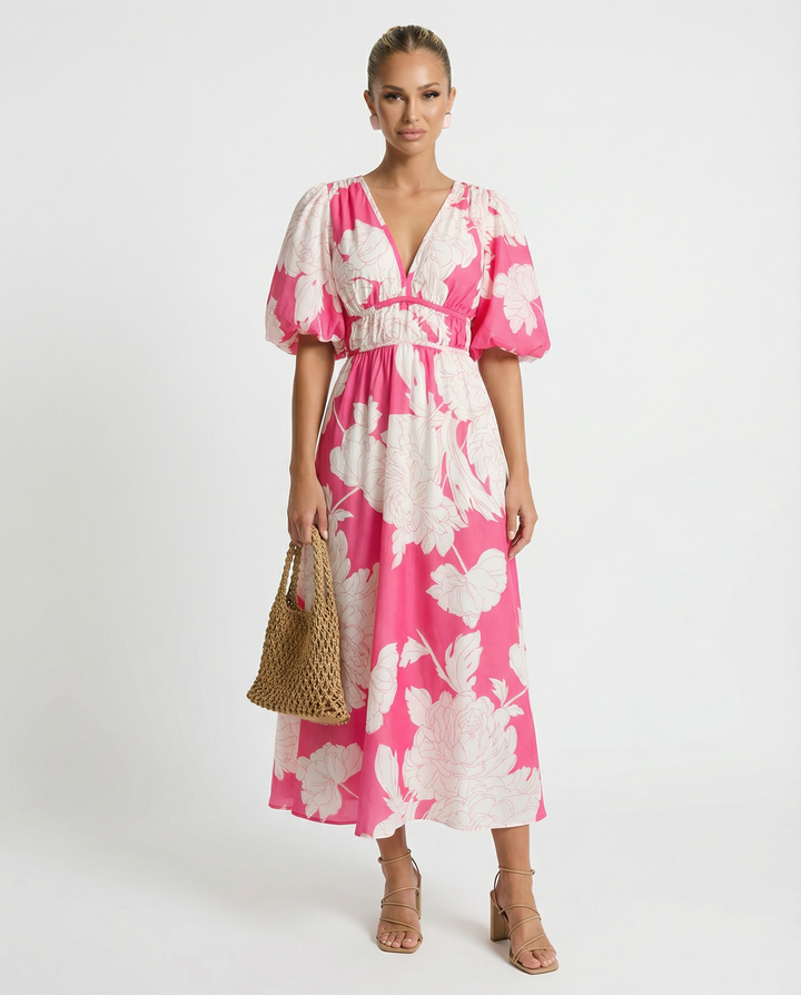 Woman styling a floral midi dress with an adjustable waist tie on a plain background.