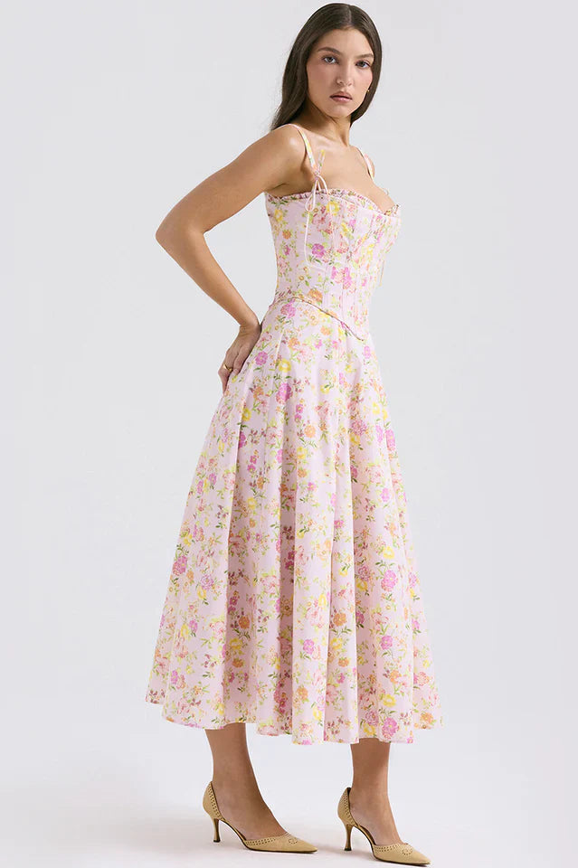 Female model wearing a sweetheart neckline floral midi dress against a plain background.