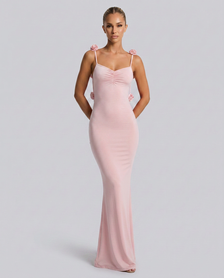 Model wearing a sleeveless gown with a smooth draped shape.
