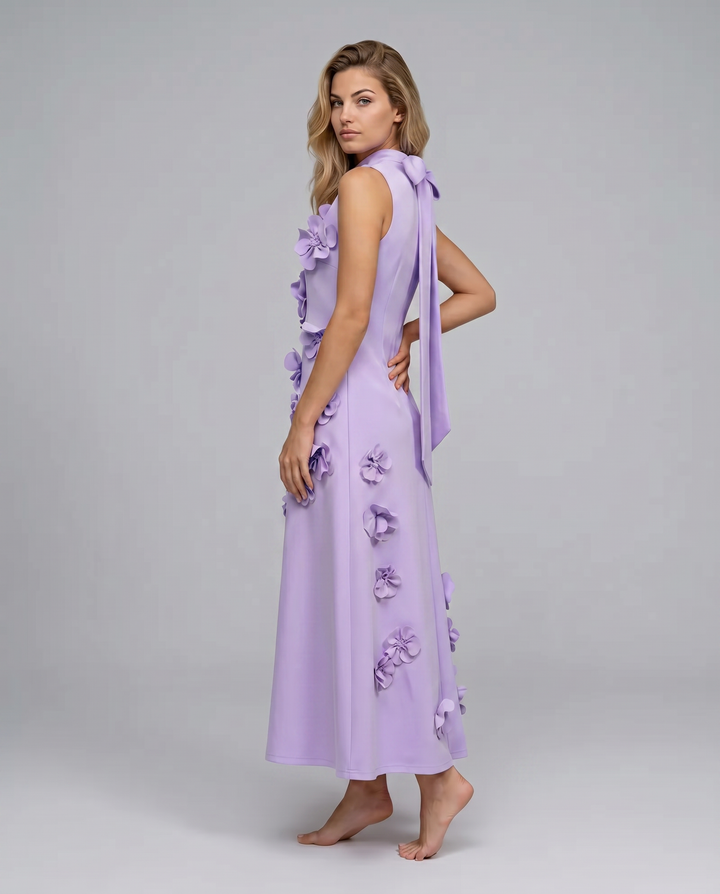Female model in a straight silhouette maxi dress on a plain background
