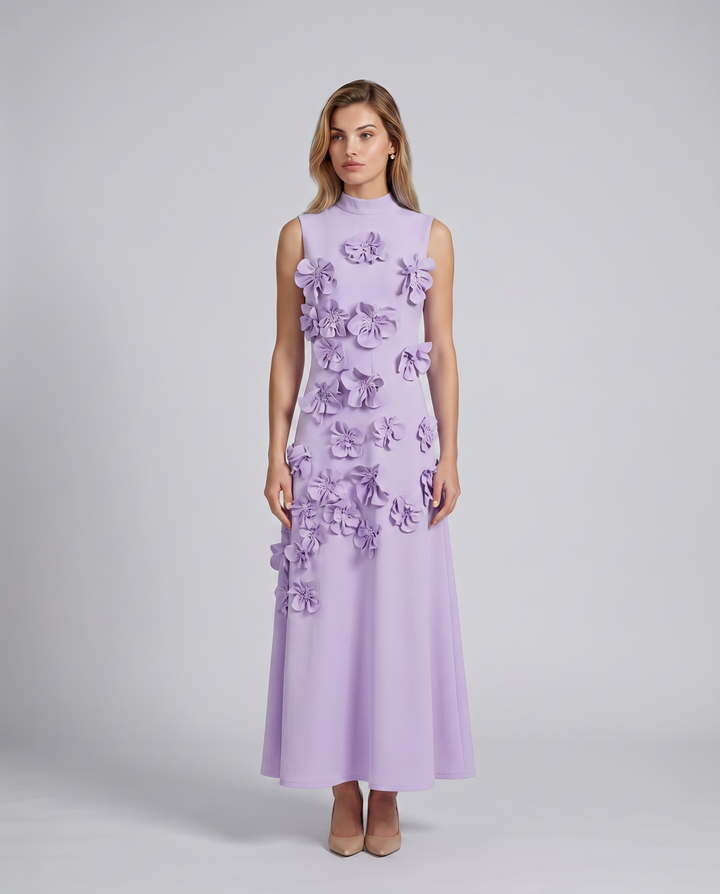 Female model in a high neckline maxi dress with raised floral accents.