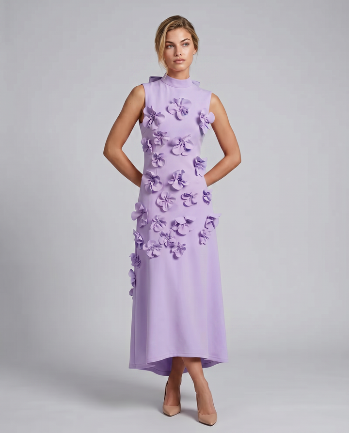Woman styled in a floral textured long dress with a clean neckline.