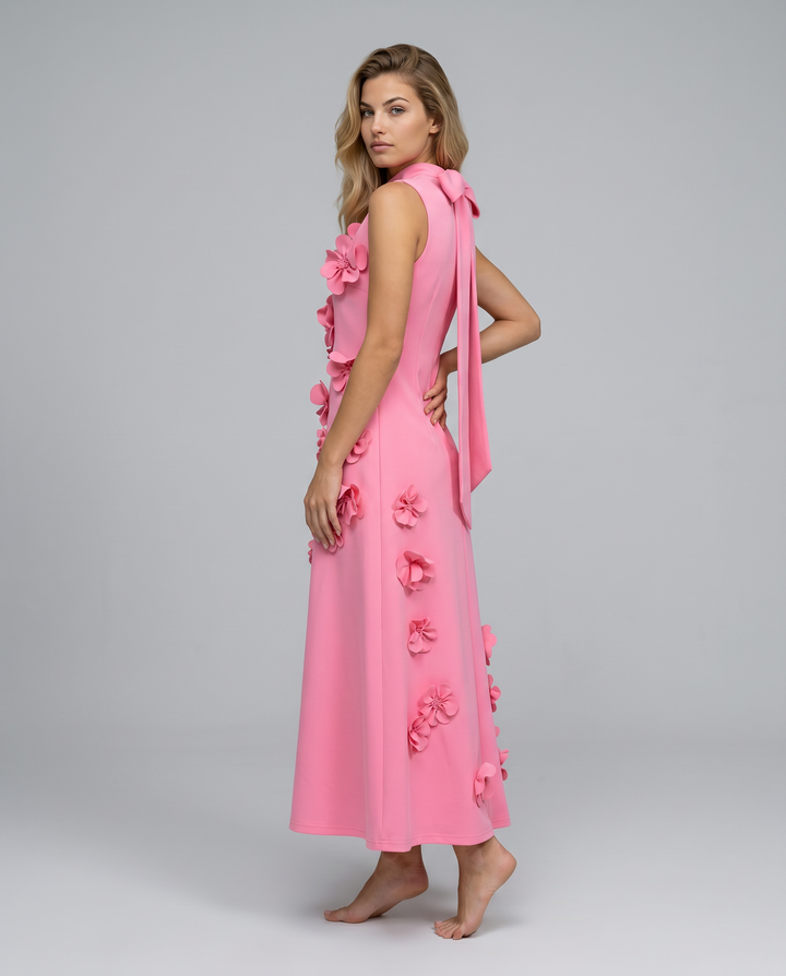 Female model wearing a structured sleeveless maxi dress with floral detailing.