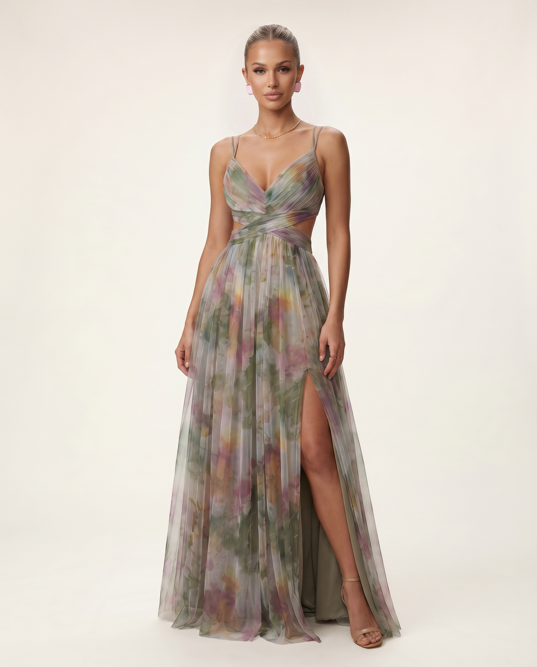 Female model wearing a green and orange floral maxi dress on a plain background.