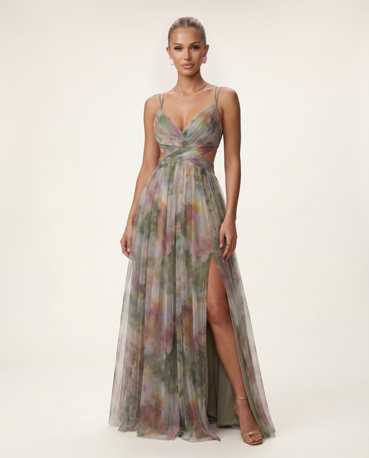 Female model wearing a green and orange floral maxi dress on a plain background.