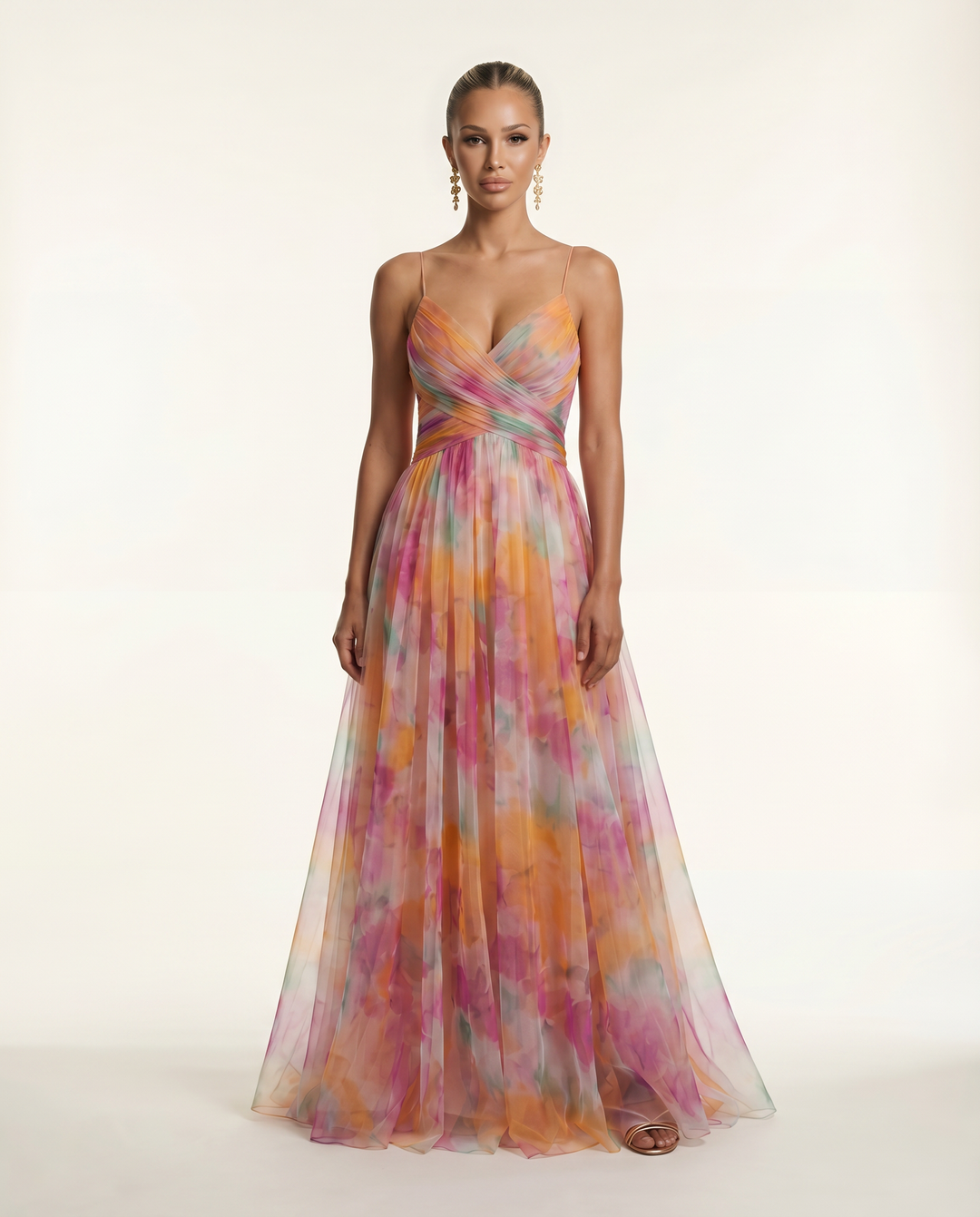 Female model wearing a floral maxi dress with thin straps on a plain background.