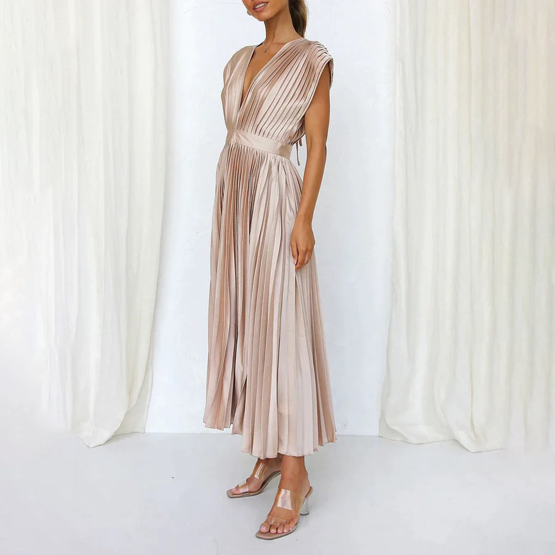 Woman showcasing a soft flowing dress on a clean background.
