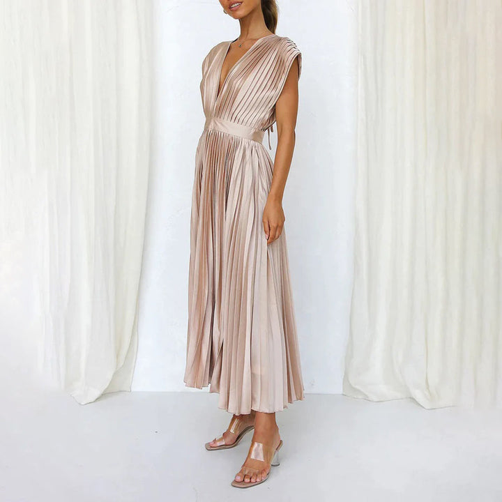 Woman showcasing a soft flowing dress on a clean background.