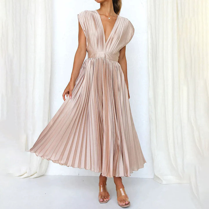 Woman wearing an elegant dress against a plain background.
