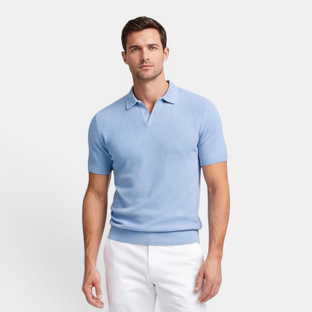  Model wearing a short sleeve knit polo shirt with a neat polished appearance.