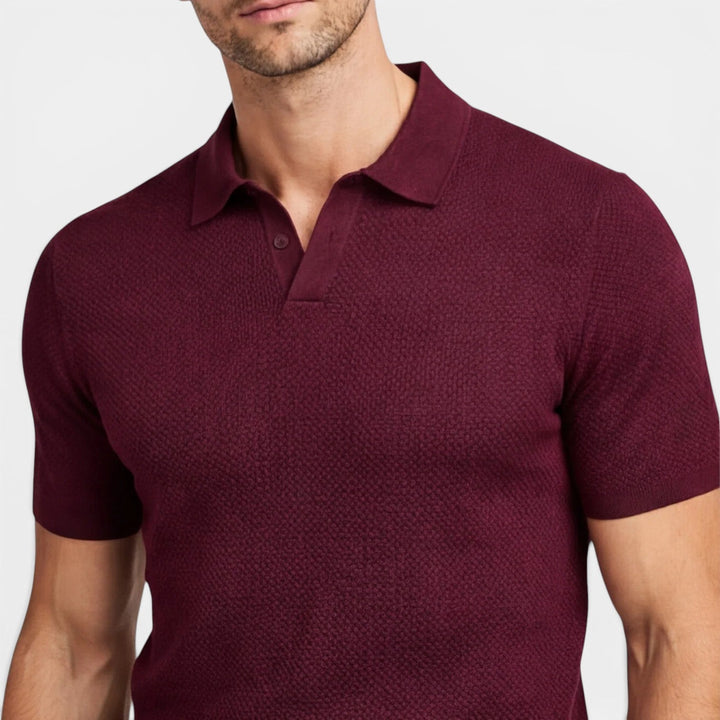  Model in a soft-looking knit polo shirt with a clean modern silhouette.
