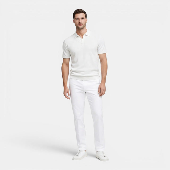 Model wearing a knit polo shirt on a plain background with a clean slim fit look.
