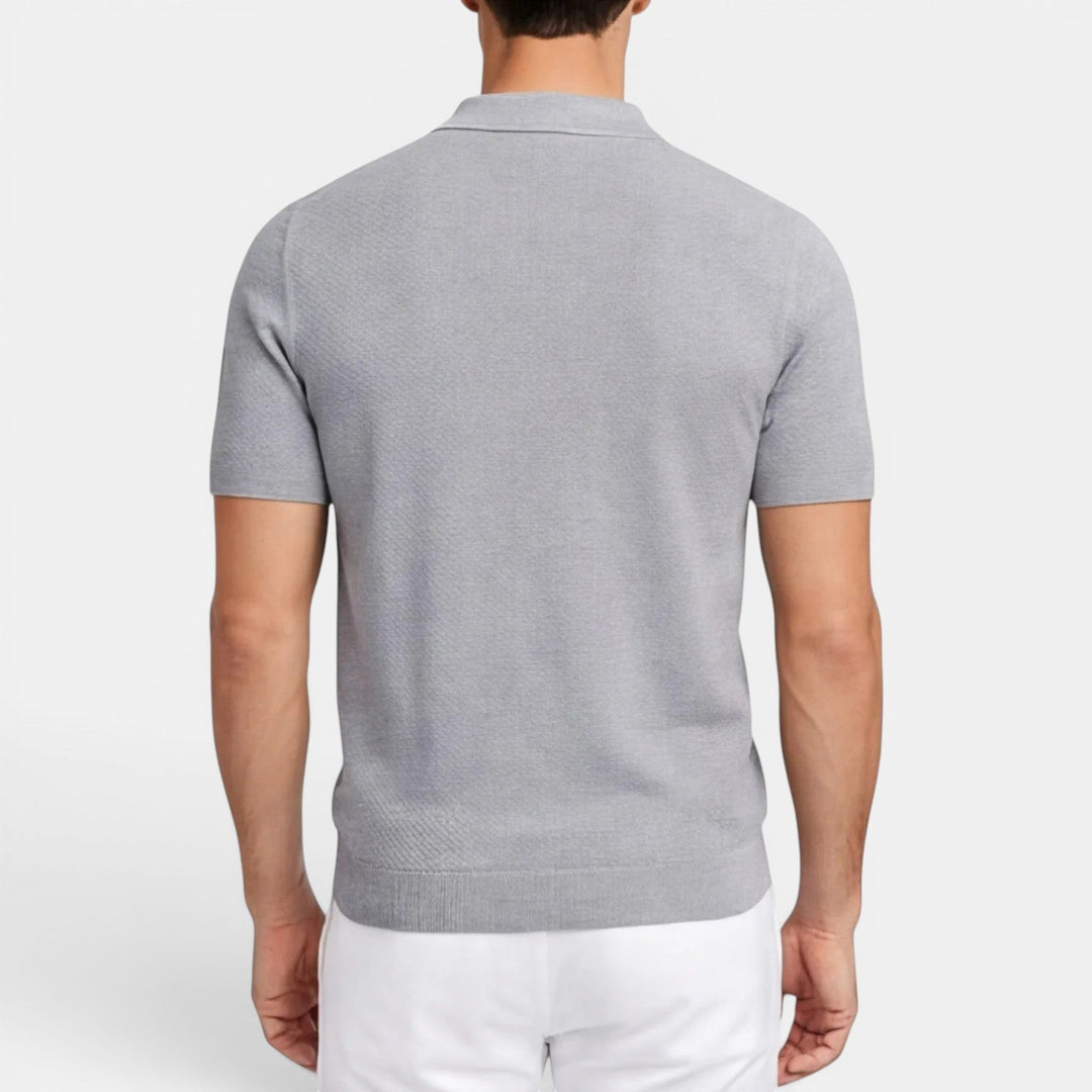  Model in a slim fit knit polo shirt shown with a smooth everyday look.