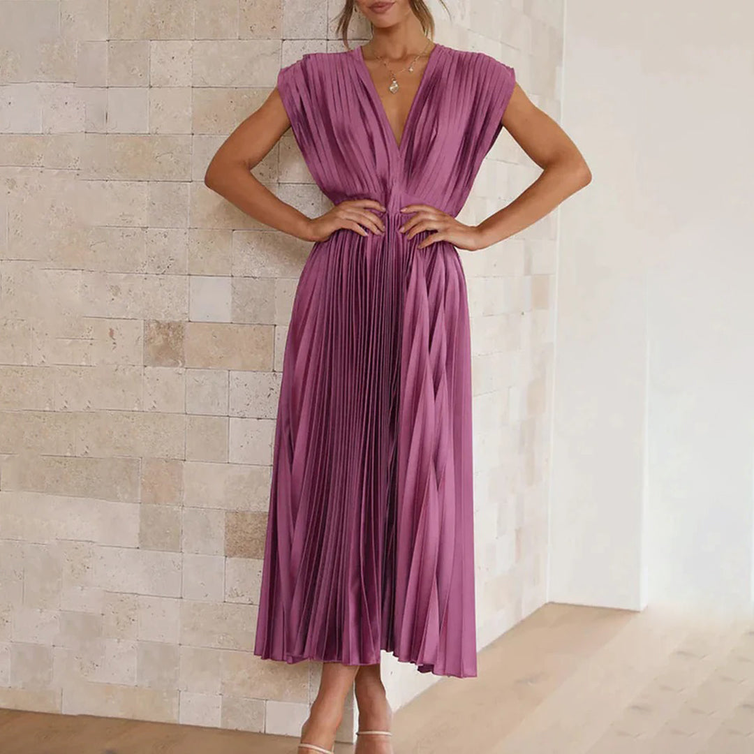 Female model in a polished dress against a plain background.