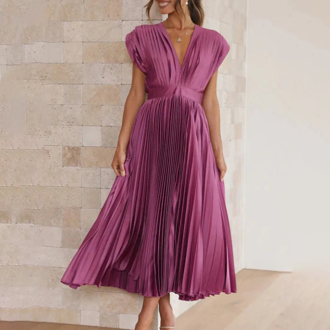 Model wearing a graceful women’s dress on a clean background.