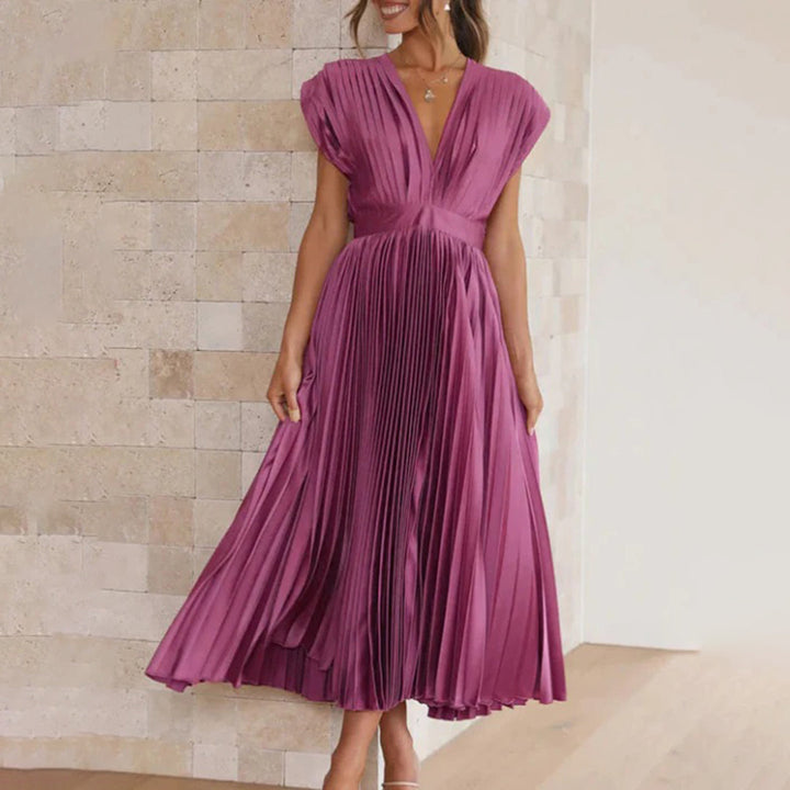 Model wearing a graceful women’s dress on a clean background.