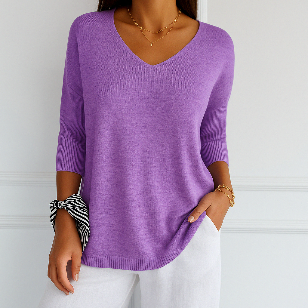 Minimalist product image of women’s top on plain background.