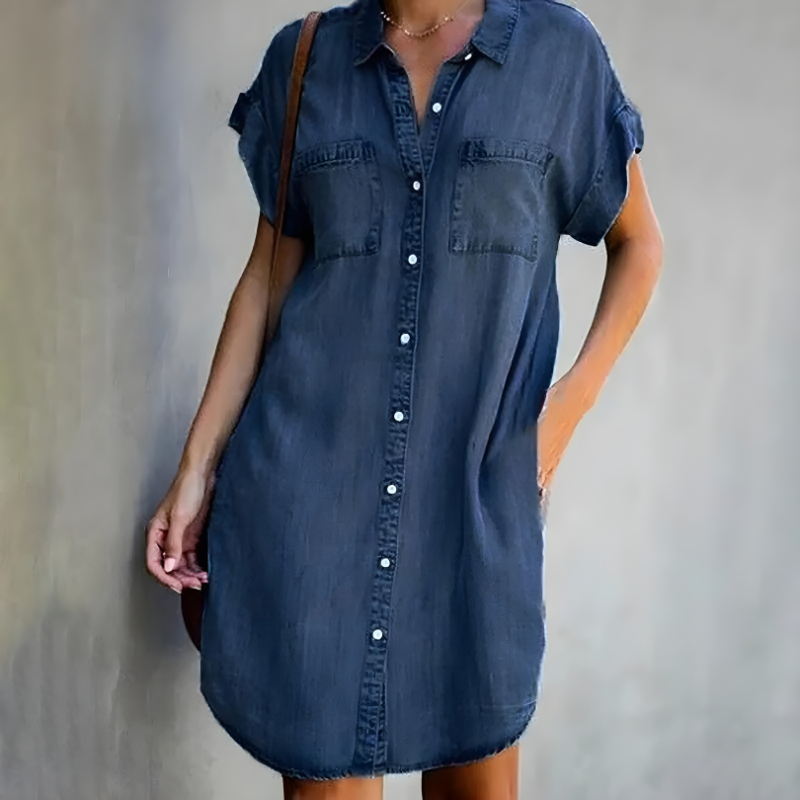  Female model showcasing an elegant layered dress on a plain background.