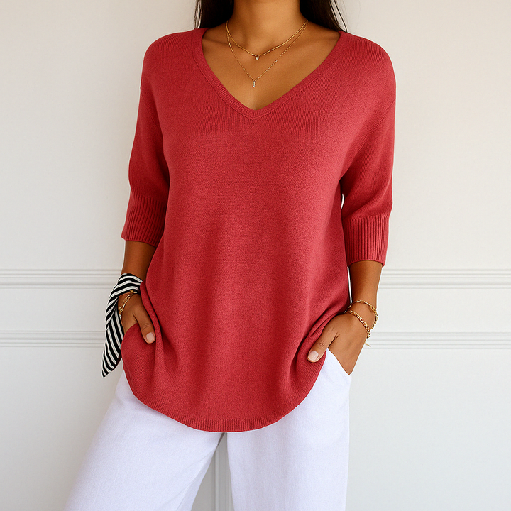 Feminine knit top silhouette shown on plain background.