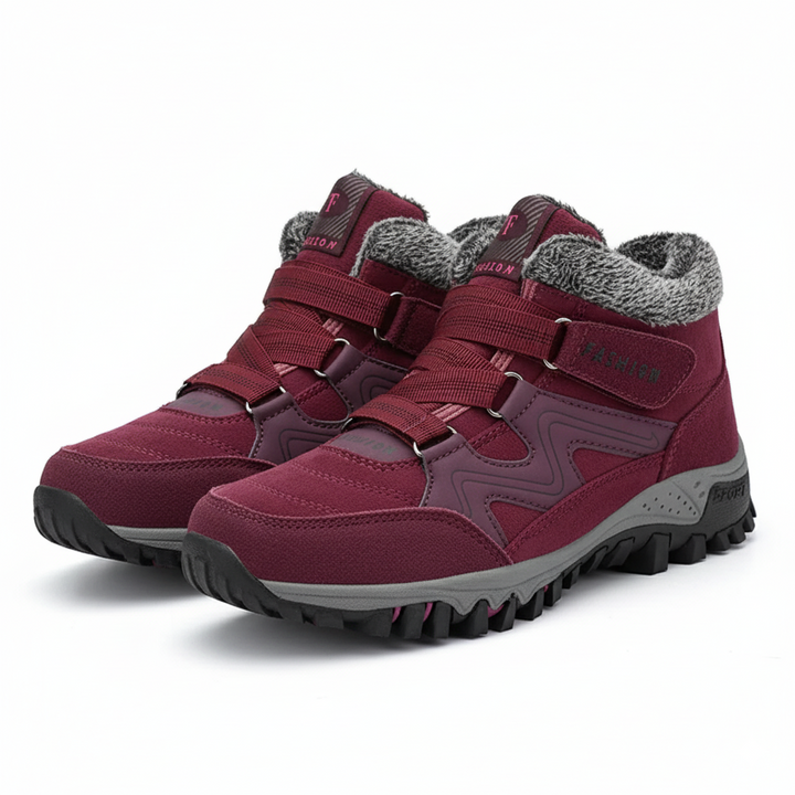Waterproof women’s boots displayed on feet against a simple plain background.
