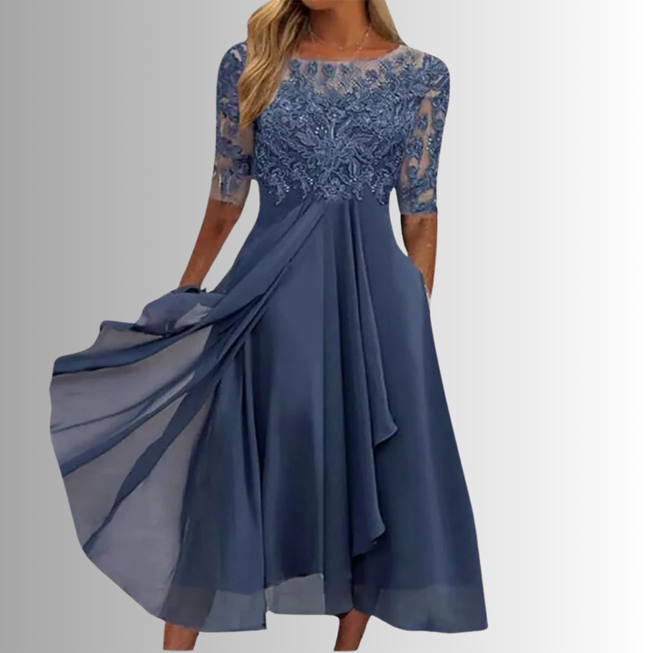 Female model wearing a lace midi dress on a plain background