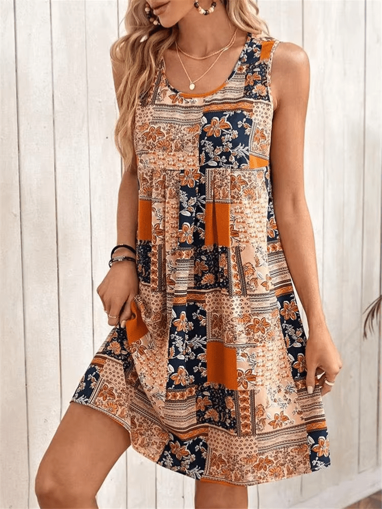 Boho patchwork mini dress on plain background with floral and geometric print.
