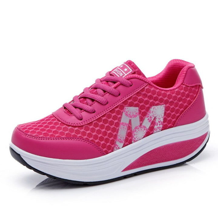 Breathable sneakers on a simple plain backdrop.