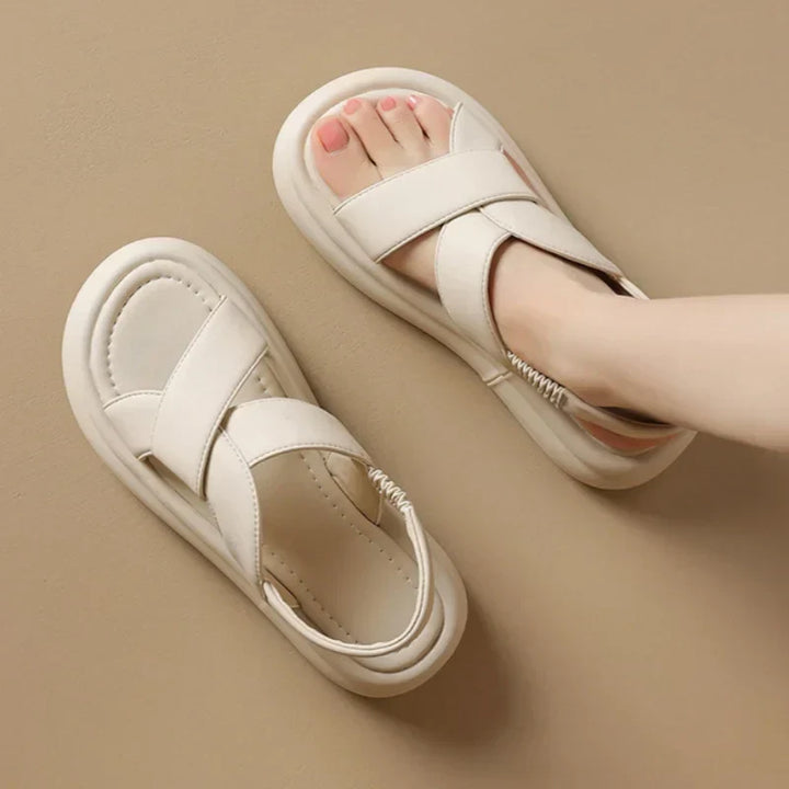 Women’s wedge sandals shown on a plain background with cushioned footbed and supportive sole.