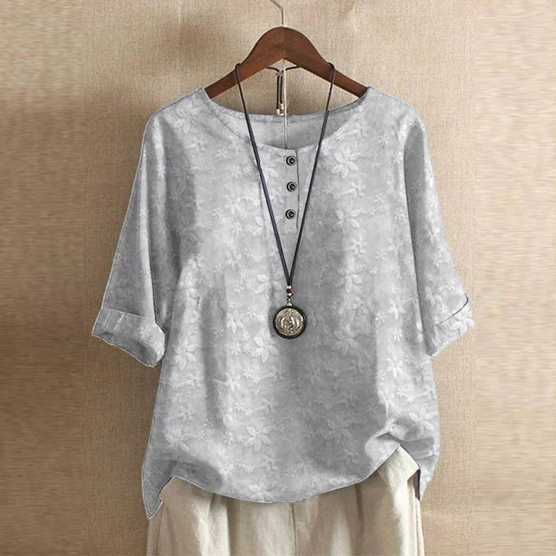 Timeless vintage blouse presented on a plain background with delicate buttons and graceful gathers
