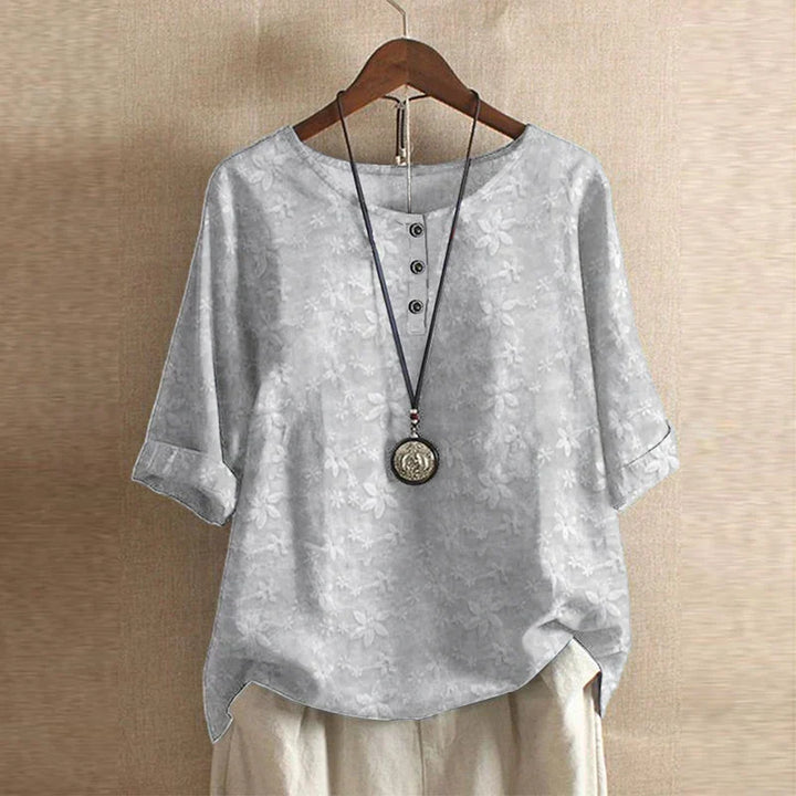 Timeless vintage blouse presented on a plain background with delicate buttons and graceful gathers