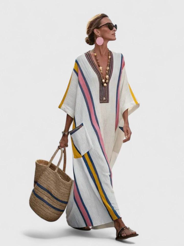  Model wearing a relaxed kaftan dress with pink, green, and white stripes on a plain background.