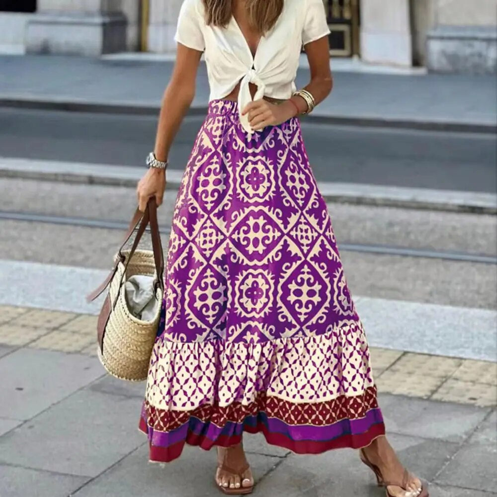 Flowing A-line boho skirt with contrast border hem on a plain background.