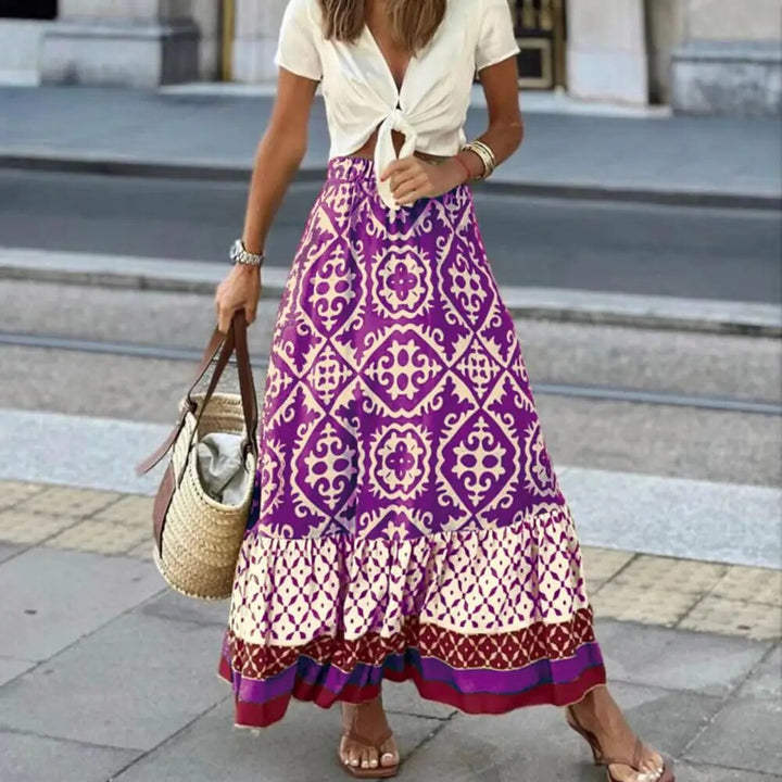 Flowing A-line boho skirt with contrast border hem on a plain background.